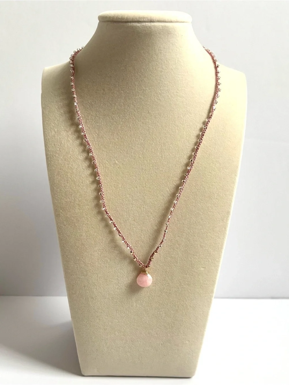 Pink silk thread necklace with a beautiful pink coral briolette stone